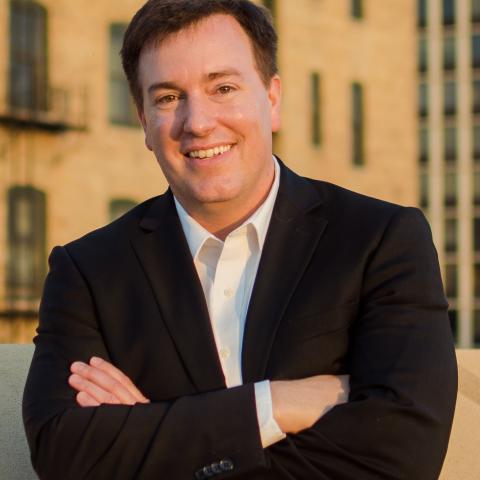 Photo of Dr. Michael O. Emerson leaning against a brick wall